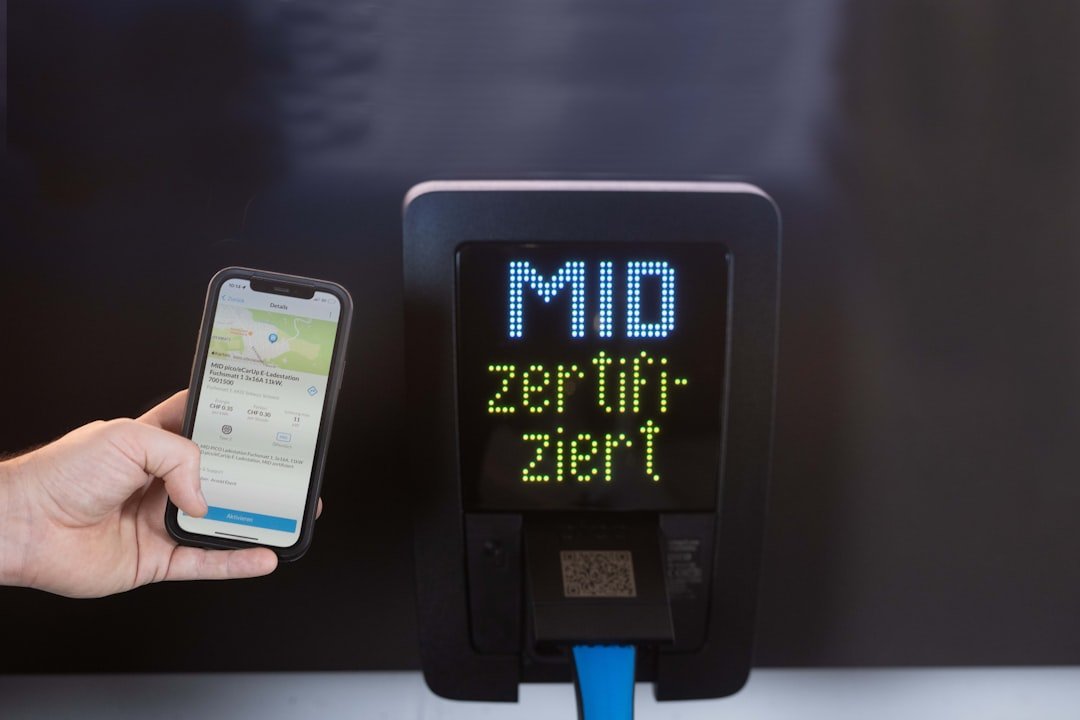 Smartphone held near mid certified charging station