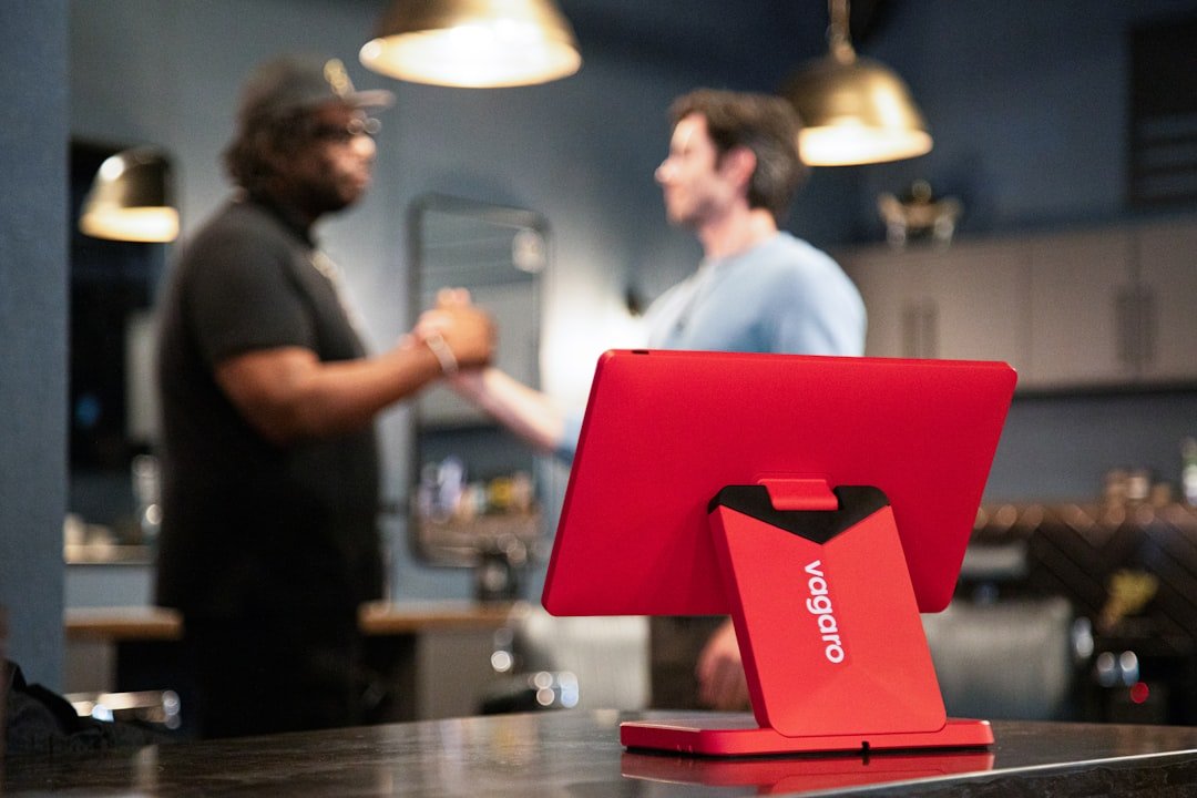 A red pos system is on a counter.