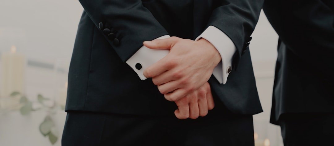 a couple of people in suits holding hands