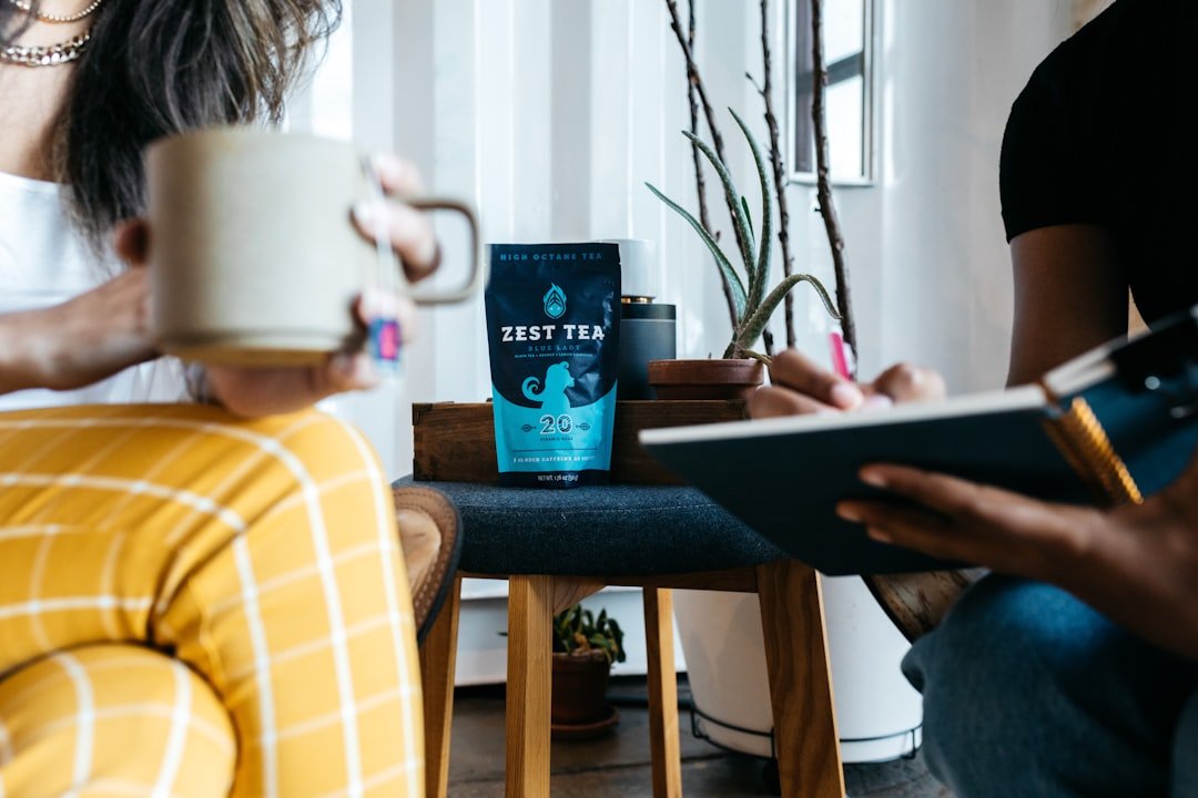 a person sitting on a chair holding a book