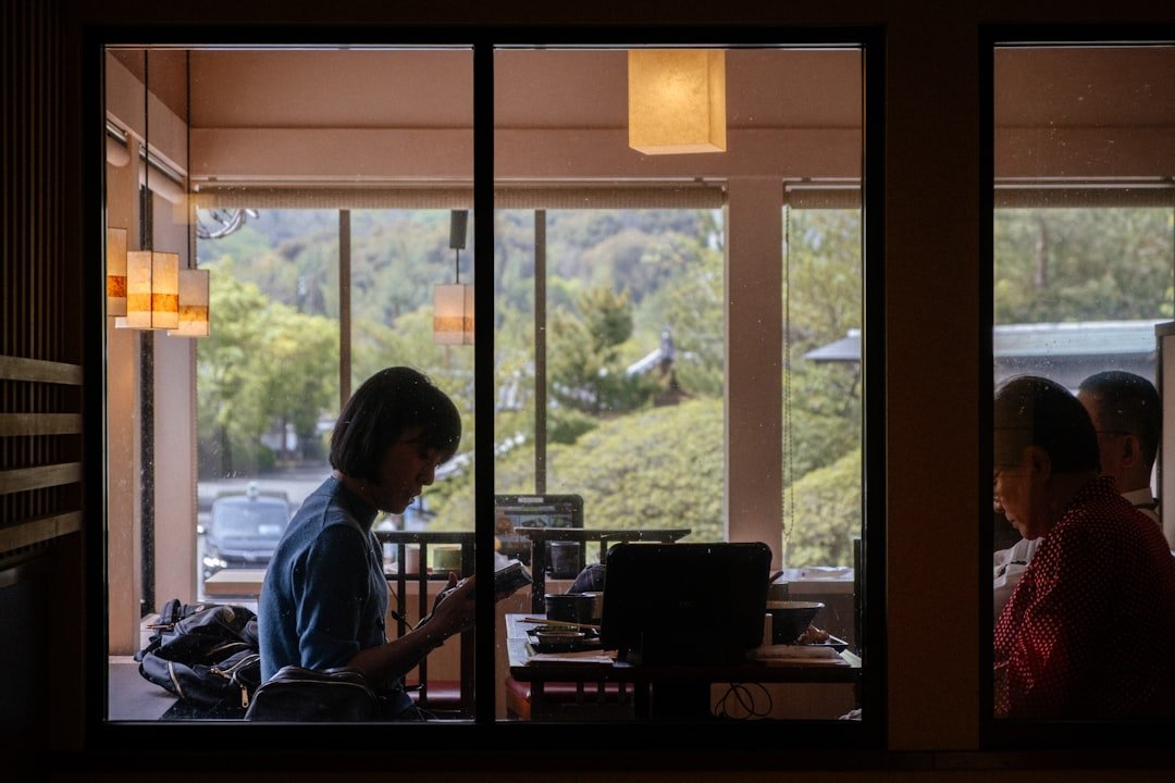People are dining indoors, with a scenic view.