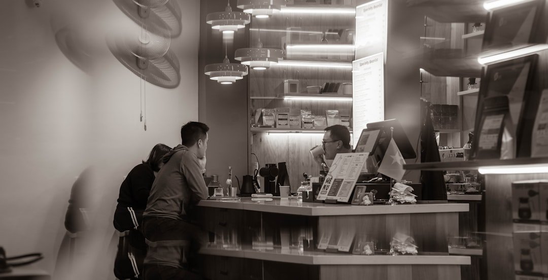 People at a counter in a modern cafe.