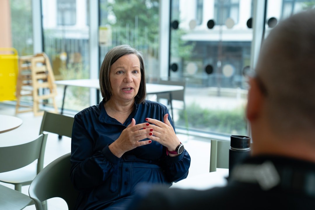 Woman talking to person across table