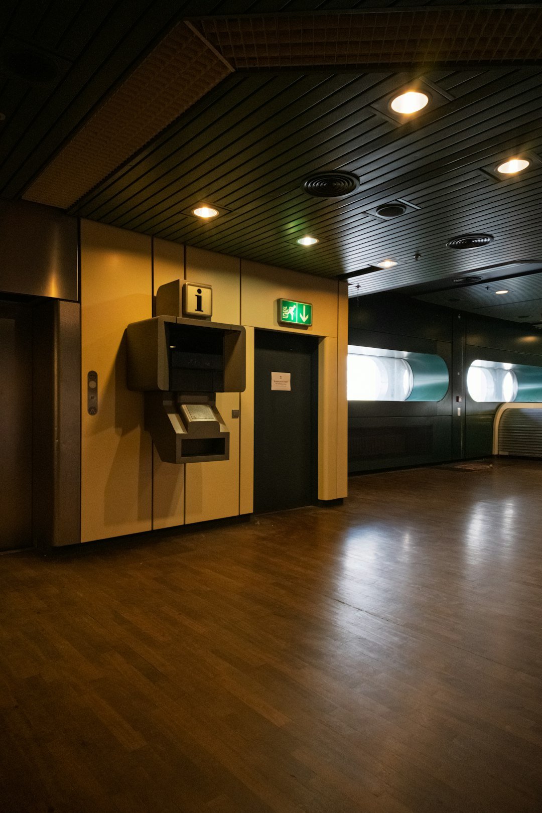 Interior of a modern building with elevator and exit sign.