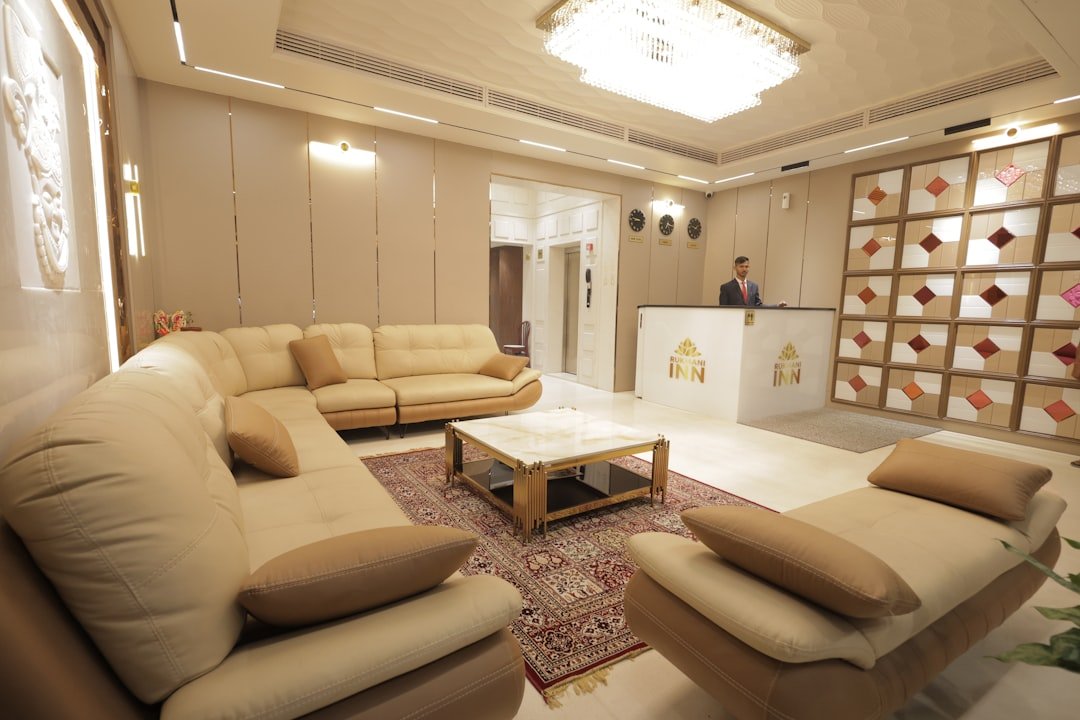Modern hotel lobby with reception desk and seating area.
