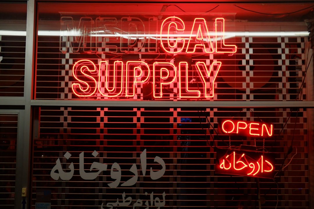 a red neon sign that says local supply