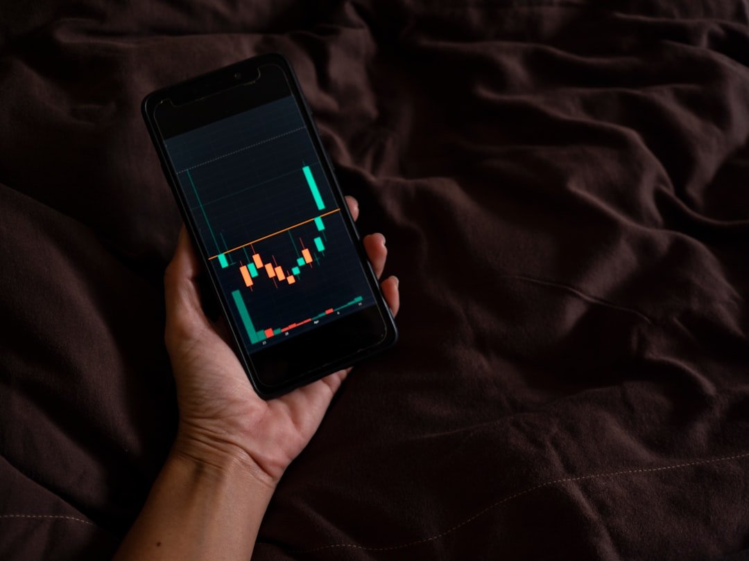 a person holding a cell phone with a chart on the screen