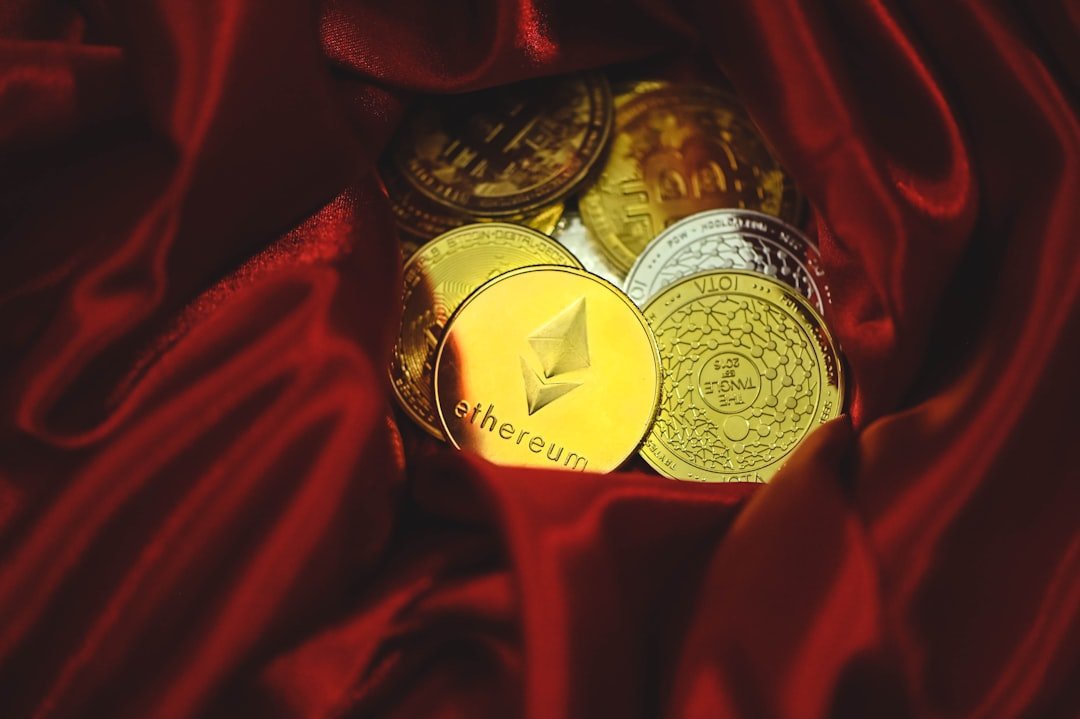 a pile of gold and silver coins sitting on top of a red cloth