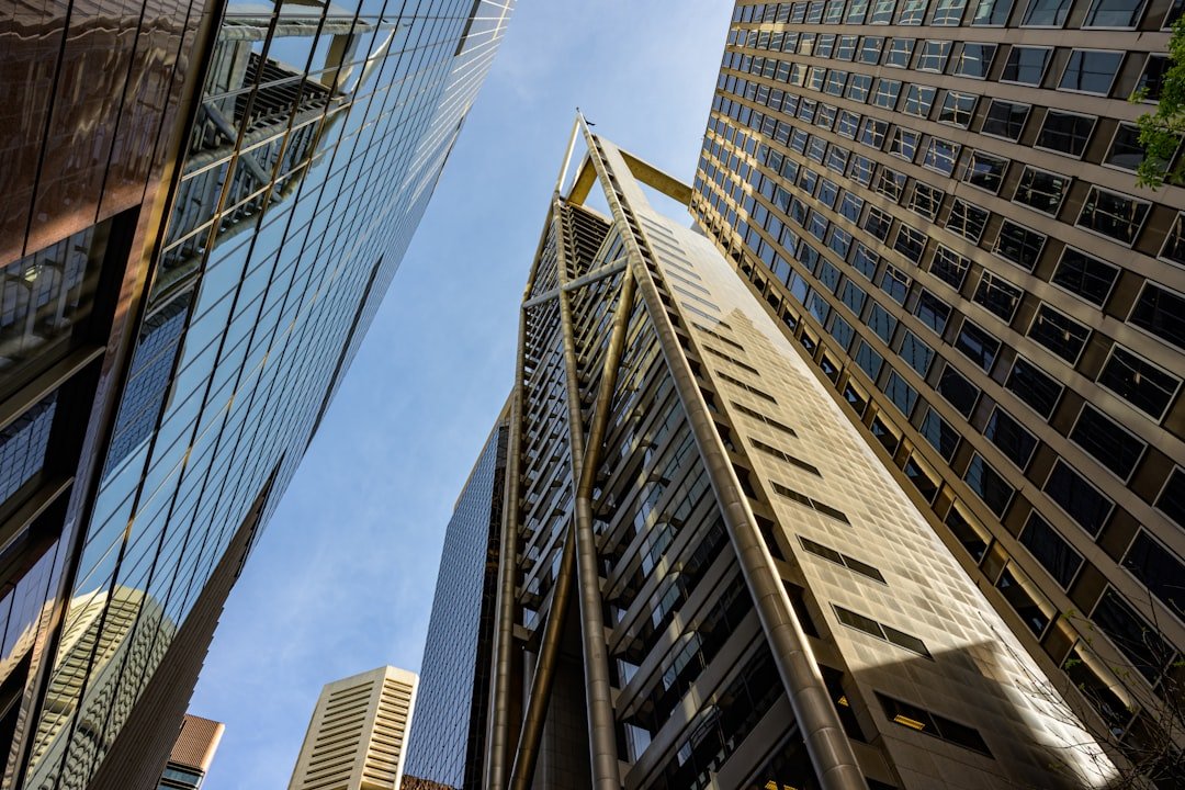 Modern skyscrapers reaching towards a clear blue sky.