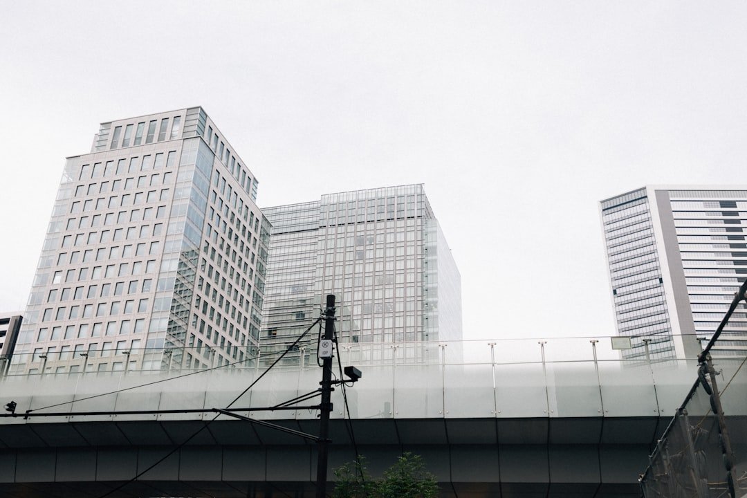 Modern glass buildings under a cloudy sky