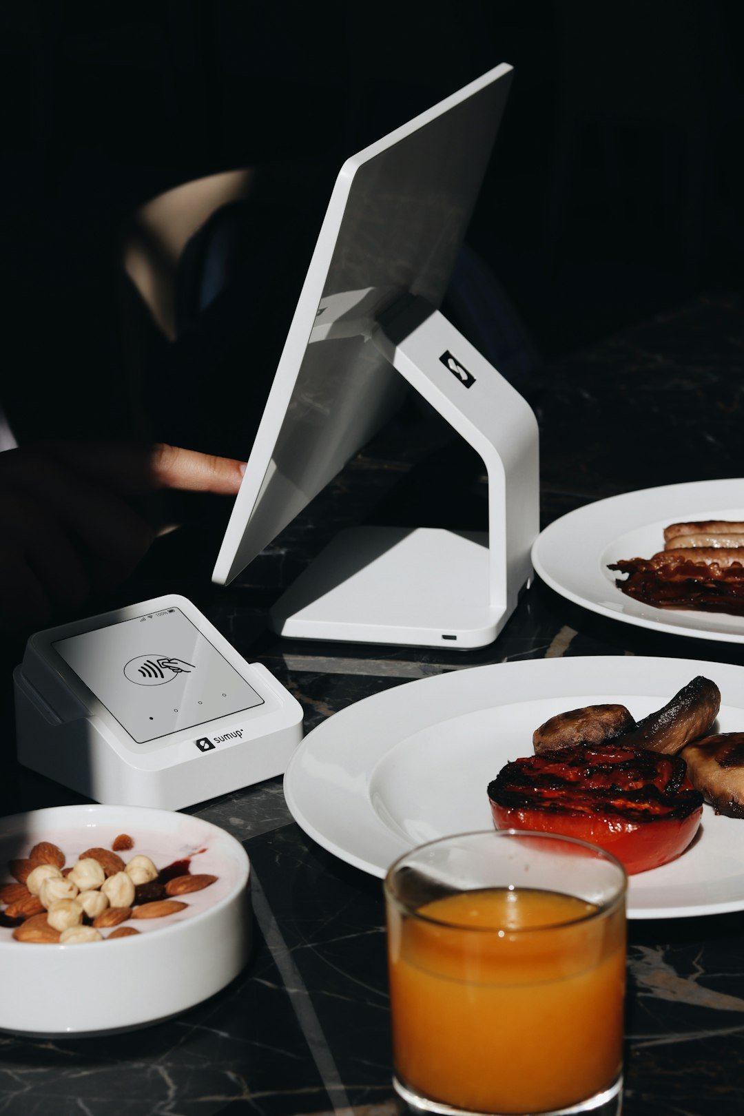A table topped with plates of food and a laptop computer