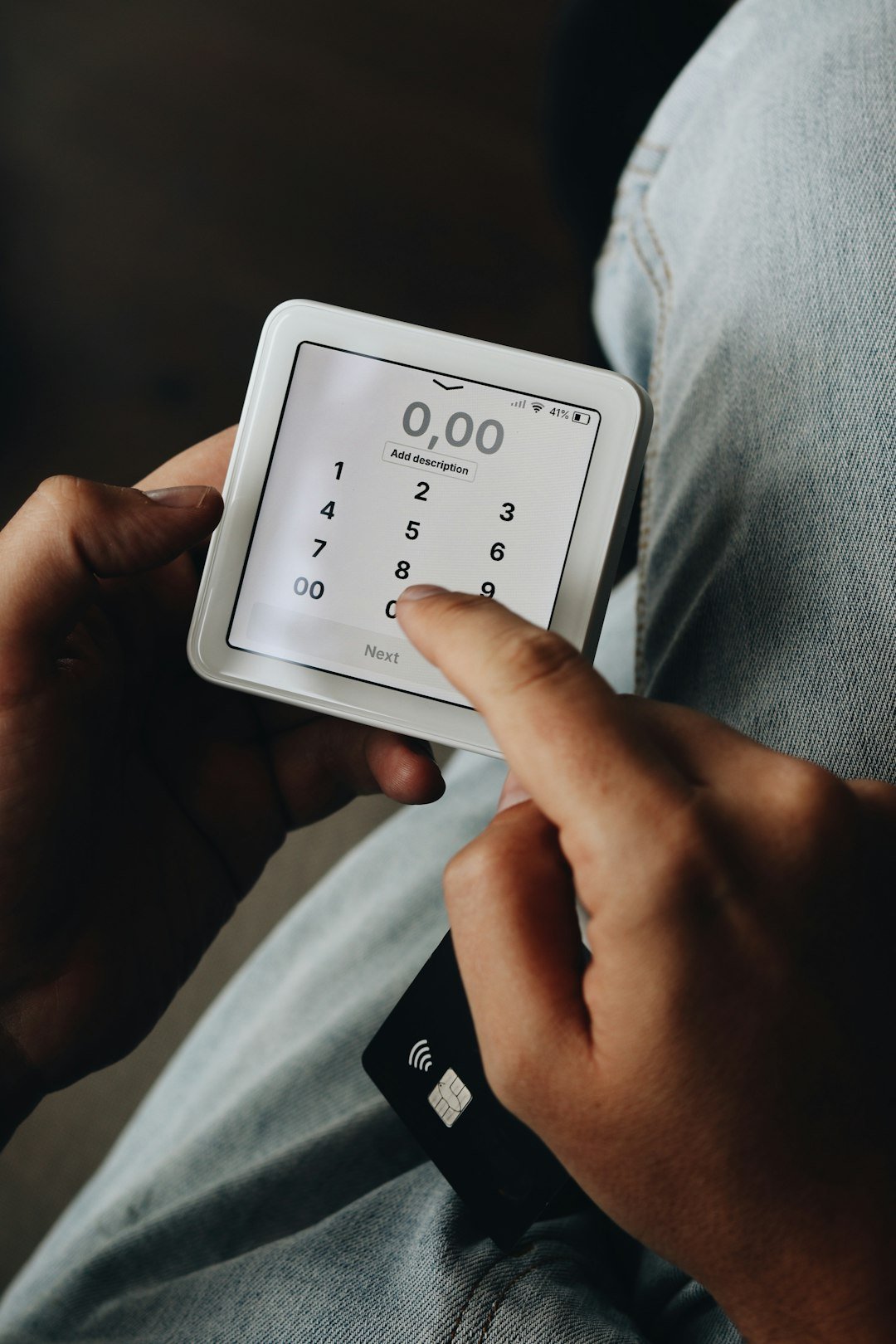 A person sitting on a couch holding a smart device