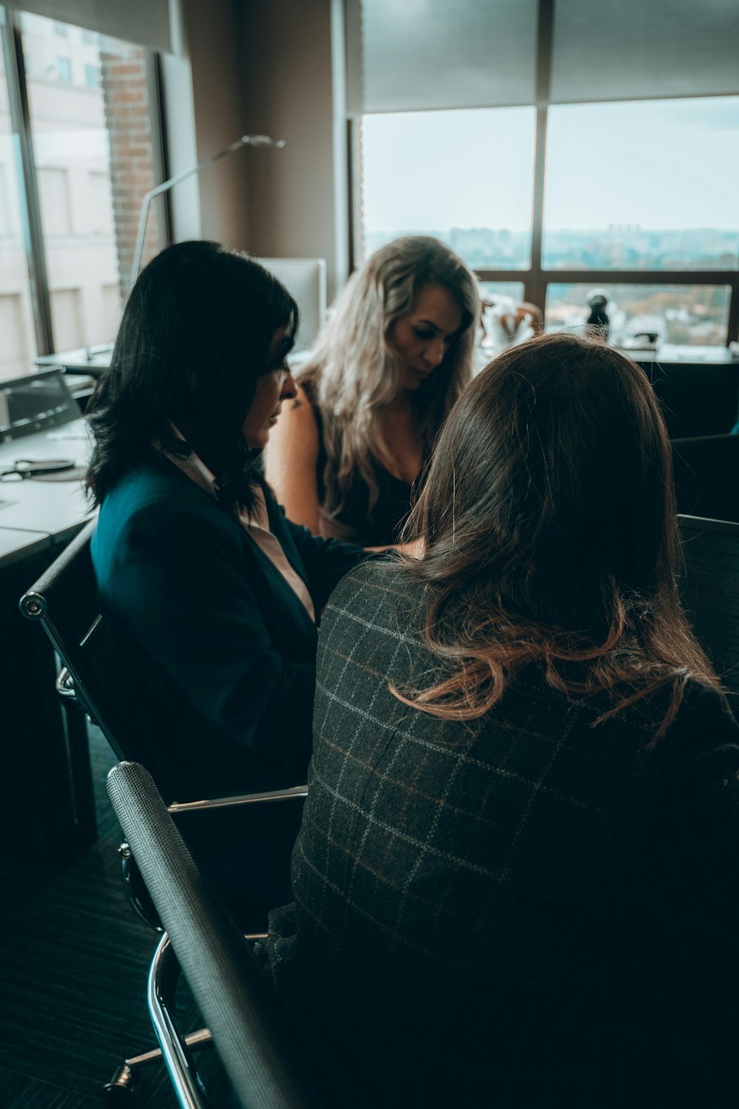 a group of women sitting around each other in a room