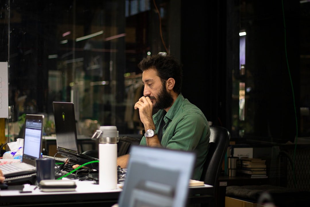 a man sitting in front of a laptop computer