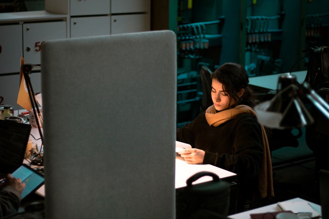a woman sitting at a desk in front of a computer