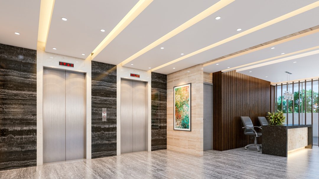 Modern lobby with elevators and reception desk.