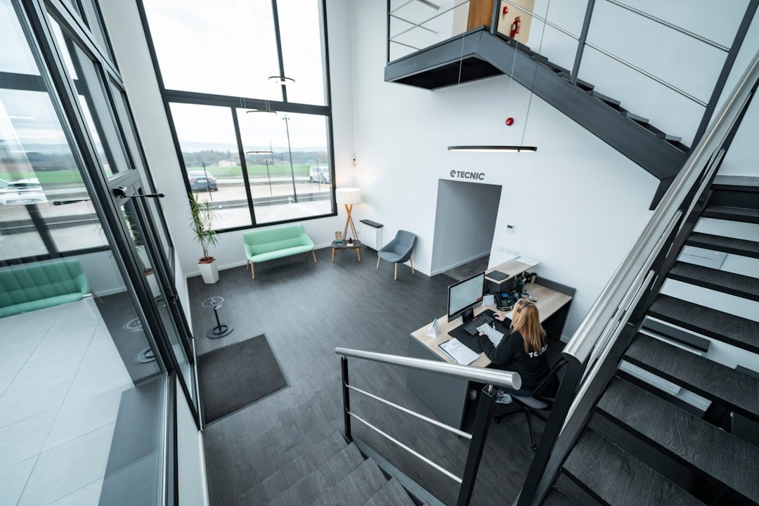 A modern office reception area with a staircase.