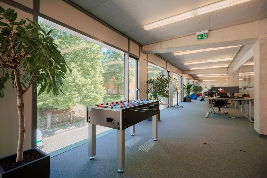 a room with a foosball and a potted plant