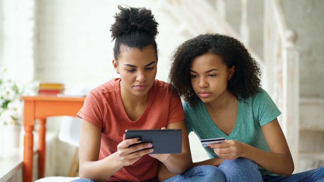 Two young women looking at a tablet device.