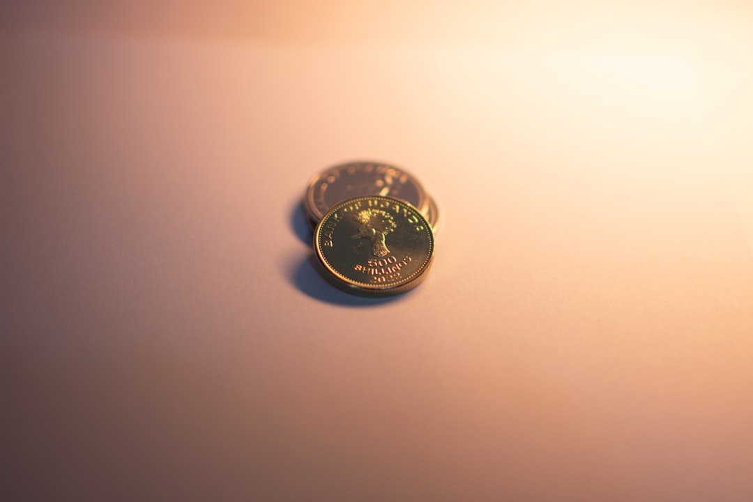 Gold coins are illuminated against a neutral background.
